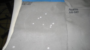 MarChem CFI developed Aqua-tite, a treatment that restores water repellency to fabric. Aqua-tite is very low in volatile organic compounds ( VOC ) and is safe to use near bodies of water. The photo shows water beading up on a test panel of treated fabric. Photo: MarChem CFI.