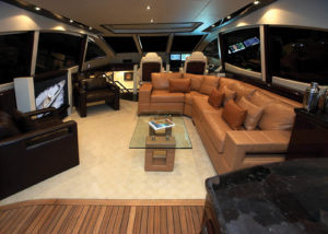 A latte-brown ostrich-leather sectional sofa adds exotic luxury to the salon of the Lazzara LSX75 express cruiser. Ostrich is one of the more delicate exotic hides. A faux-ostrich choice like Majilite Baby Ostrich is a hardy substitute. Photo: Lazzara Yachts.
