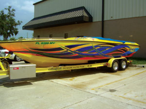 This new 29-foot Velocity pleasure boat was factory-molded in a bright yellow gel coat. Wrap This Ink designed a full-coverage wrap for the sides and opted to utilize contour-cut digitally printed graphics for the boat deck. This is considered a "partial wrap," which can save clients money because there is no need to cover the full surface of the boat. Wrap This Ink installers laid down each side of this boat in less than one hour.