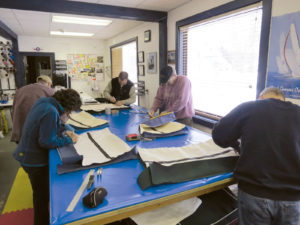 Students at Hood Marine Canvas Training assemble cushions with an angled side, a style most commonly used on sailboats.