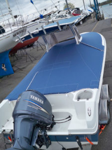 This two-piece travel cockpit cover by Lake Shore Boat Top Company Inc., Detroit, Mich., zips and attaches onto a telephone booth enclosure. The front cover is supported by an adjustable tent pole and is snapped all the way around the boat. The rear cover attaches over the console to protect instruments, and zips into the front travel cockpit cover, and snaps around the boat. The cover won an award of excellence in the 2013 MFA Fabrication Excellence Awards.