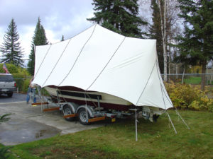 This rain and snow fly was created by Custom Canvas Alaska for a customer who appreciates its versatility. By un-staking the back three ropes, the boat can be moved around the customer’s yard, without taking down the entire cover.