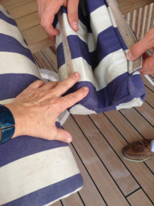  Details of a striped cylinder cushion fabricated in canvas to fit on a tube or railing. 