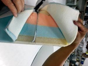 The original blue and pink polyfoam layers of this exterior cushion acted like a sponge absorbing water. These were replaced with fast-draining Dryfast foam.