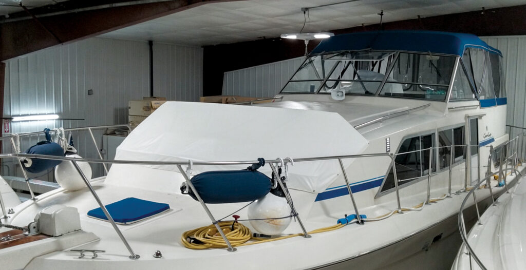 A boat in a shop, with a new cover.