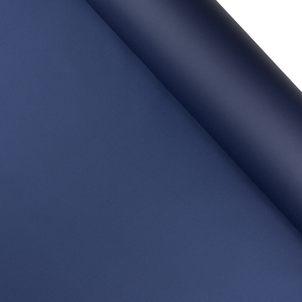 A dark blue roll of eTek™ 600D Solution-Dyed Polyester.
