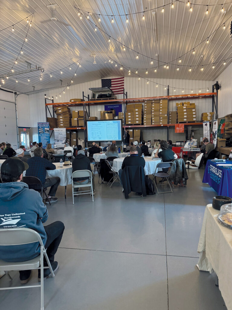 Dozens of attendees at a regional workshop in the Marine Tops Unlimited shoproom.