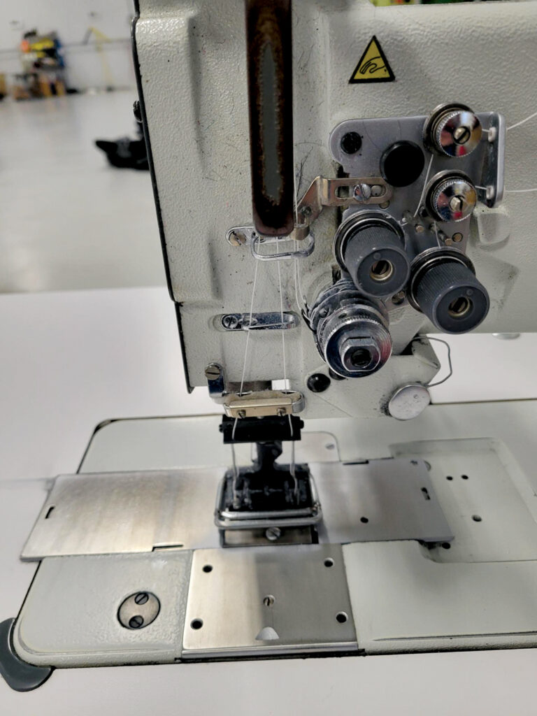 The double needles on a sewing machine at TRS Industries.