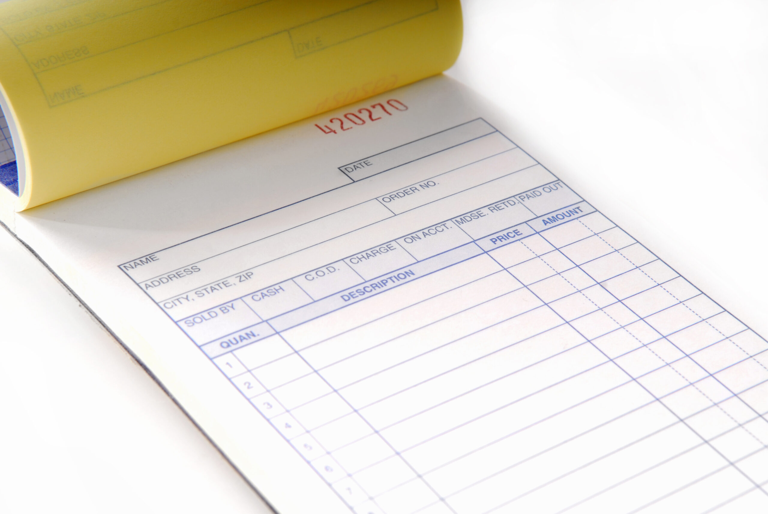 An invoice pad turned to a blank page.