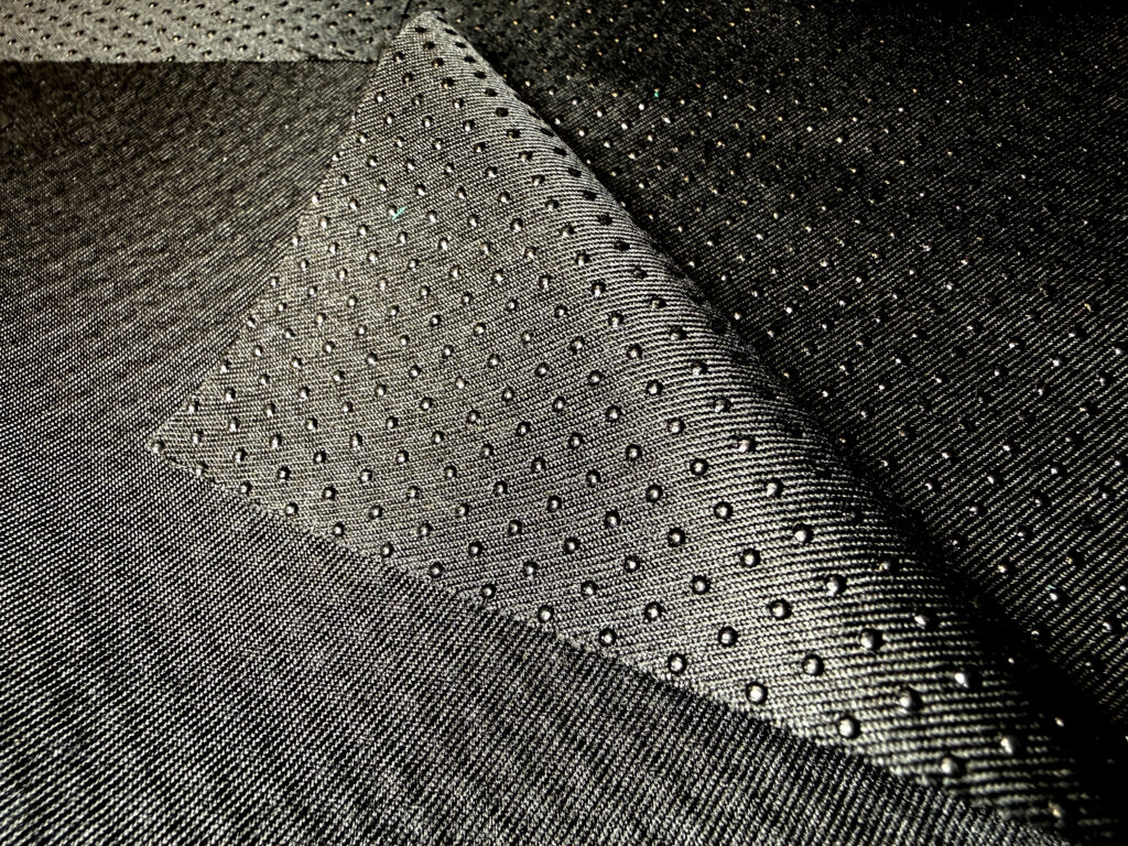 Textured black marine fabric showcasing a woven pattern with raised dots.