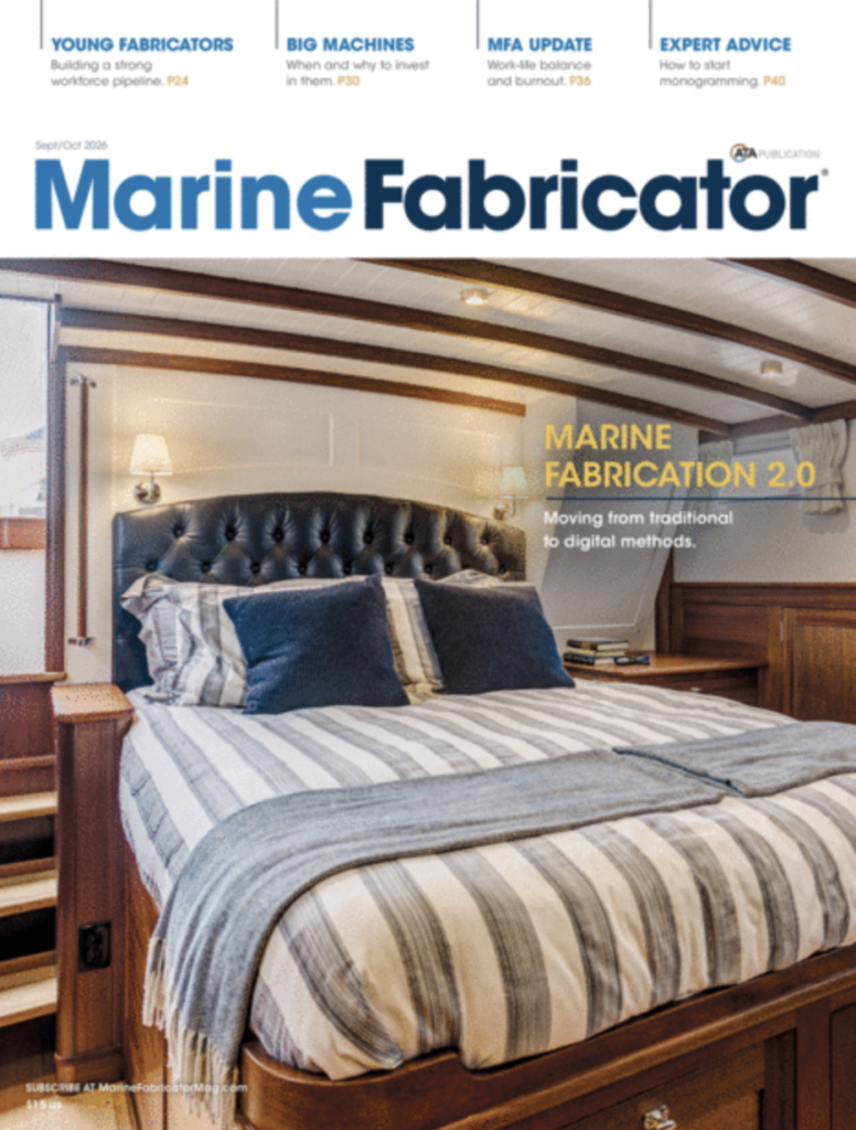 Luxurious marine cabin interior with a neatly made bed, wooden cabinetry, and striped bedding, reflecting modern design aesthetics.